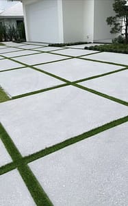 driveway exposed aggregate & sandblasted concrete with grass strips integral color stone gray